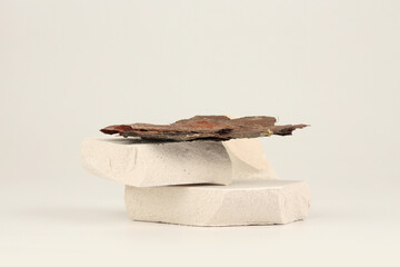 Stones and  dry bark platform podium on beige background. Minimal grunge empty display product...