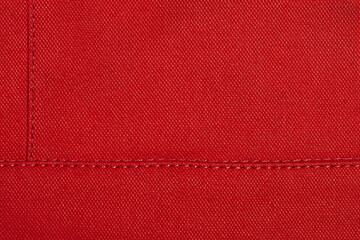 Red fabric as a background. Element of red clothing macro photo.