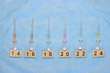 Intravenous catheters aligned in a sterile surface aligned by size 