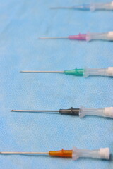 Intravenous catheters aligned in a sterile surface aligned by size 