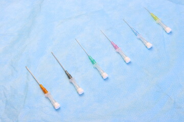 Intravenous catheters aligned in a sterile surface aligned by size 