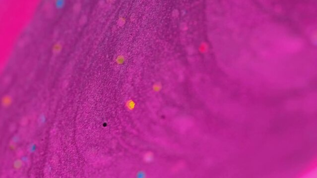 Vertical video. Glamourous background. Glitter blend. Abstract art. Defocused colorful pink purple fluid mix drop with round sparkles particles beautiful motion.