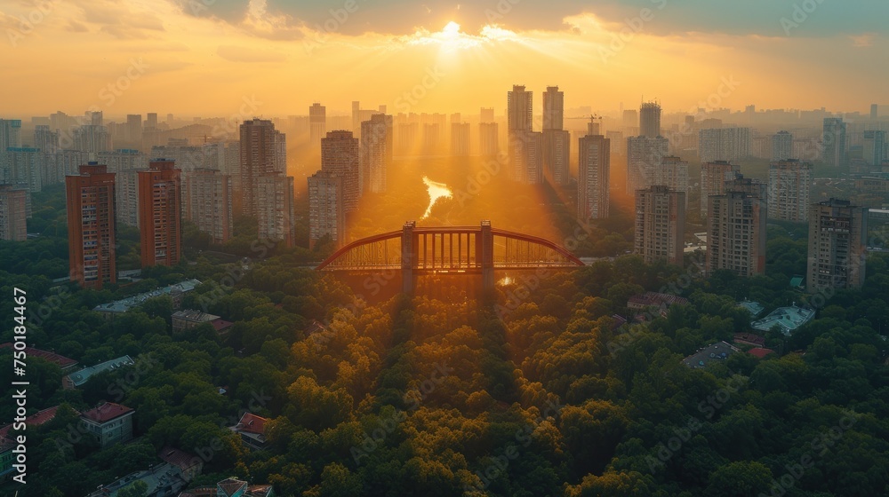 Poster an aerial view of a city with a bridge in the foreground and trees in the foreground, with the sun s