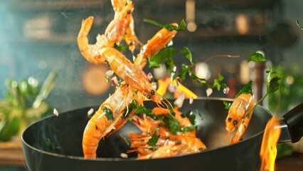Freeze Motion of Wok Pan with Flying Prawns in the Air.