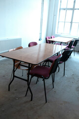 An Empty Desolate Classroom With Empty Desk and Seats
