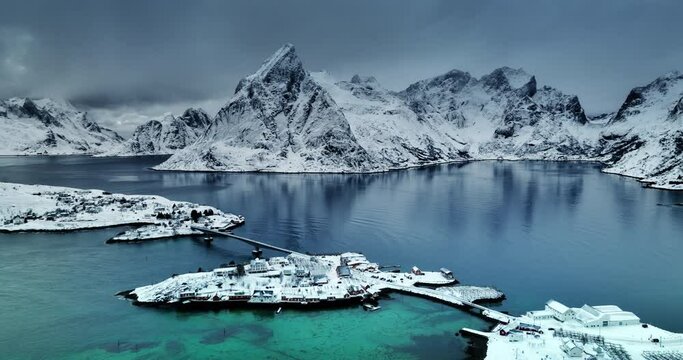 Aerial panoramic winter landscape of Fredvang bridge, picturesque fishing villages, rocky coastal seashore and mountains peaks