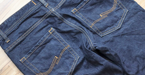 Blue jeans. Closeup of a stylish blue denim jeans. Top view - 750190061