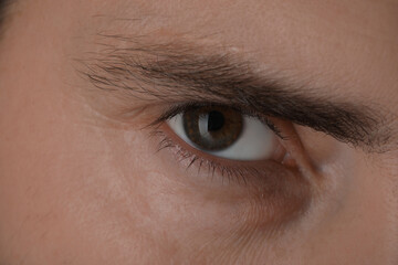 Fototapeta na wymiar Evil eye. Man with scary eyes, closeup view