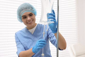 Nurse setting up IV drip in hospital