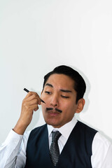 Eccentric Latin man drawing a mustache on his face