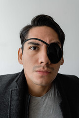 Portrait of a Latin man with a black eye patch