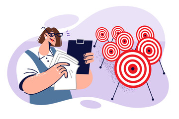 Business woman engaged in setting goals and objectives or planning, stands near many darts targets