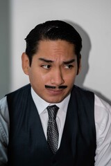 Latin man with drawn mustache headshot on white background