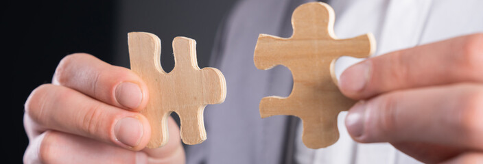 Man holding puzzle pieces