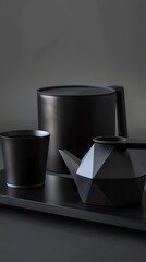 A futuristic and minimalist tea set represented by elegant geometric shapes and clean lines in black. Carbon tea set with a modern and sophisticated aesthetic.