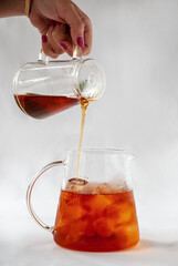 pouring tea into glass jar
