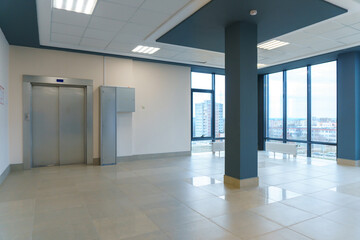 A spacious empty room with columns and no furniture. The concept of a comfortable office. The...