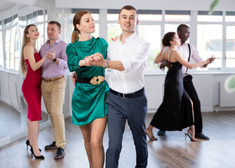 Energy man and woman are dancing classic version of waltz in couple during lesson at studio. Leisure activities and physical activity for positive people.