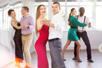 During rehearsal of reporting concert, man and woman participants of dance workshop perform figure...