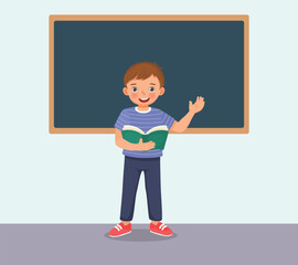 Cute little boy holding book standing in front of class reading speaking