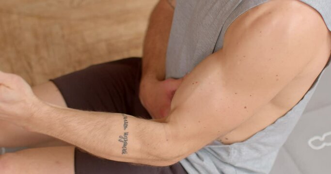 Male arm movements, close-up. Fit man boost his metabolism. Kickstart day with physical activity and energy. Morning ritual involves series of exercises aimed at stretching, strengthening body. 