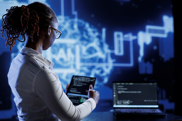 BIPOC engineer updating neural networks made up of interconnected nodes, writing intricate binary...