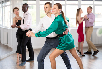 Energy man and woman are dancing classic version of waltz in couple during lesson at studio. Leisure activities and physical activity for positive people.