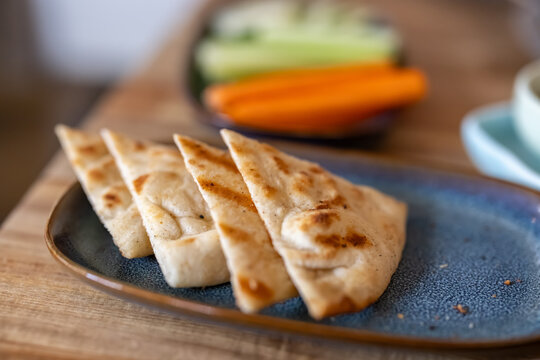 Freshly grilled pita bread on a plate in an upscale Mediterranean restaurant 
