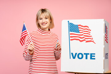Cheerful smiling young woman supporter holding American flag American presidential election