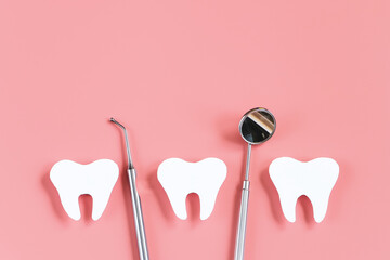 Dental care concept. Dental tools on pink background. Happy dentist day. Paper cut mockup of tooth.