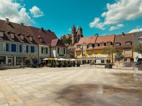 Breisach, Germany, Europe, July 19, 2023, Town Square in Breisach, Germany on a Beautiful Summer day. A beautiful church can be seen in the distance. Tourist shop and cafe in the foreground of view.
