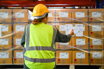 operation worker woman checking and inspecting cargo for stack items for shipping. Staff checking...