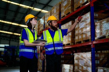 operation workers checking and inspecting cargo for stack items for shipping. males worker checking the store factory. industry factory warehouse. Worker Scanning Package In Warehouse.