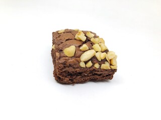 Brownie cake with bitten peanut topping isolated on white