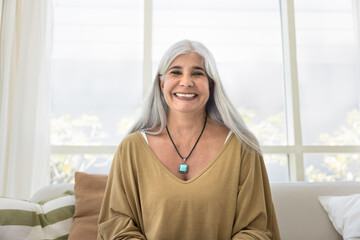 Happy grey haired senior woman talking on online video conference call screen view. Head shot portrait of old female model looking at camera with toothy smile, laughing, enjoying communication