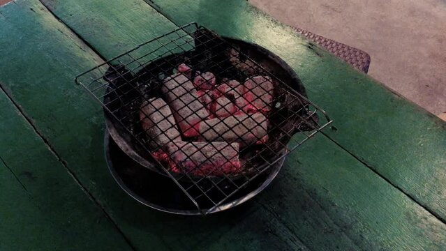 February 14, 2022 - Jomtien Beach, Chonburi Thailand. A barbecue sits waiting for seafood at a Thai barbecue restaurant.