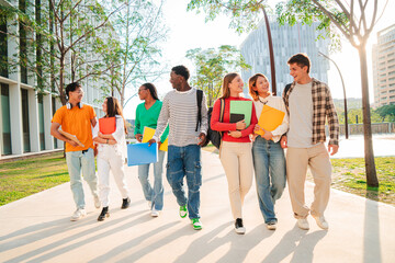 Big group of multiracial students walking together at university campus. Happy internacional...