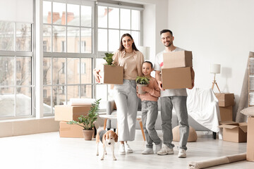Fototapeta na wymiar Happy family with cardboard boxes and Beagle dog in room on moving day