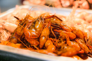 Fried shrimps with salt and pepper on a food stall