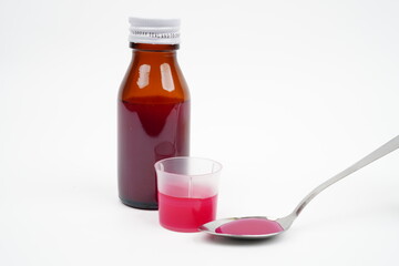 Red cough syrup isolated on white background