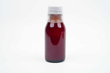 Transparent brown bottle with red liquid medicine concept background