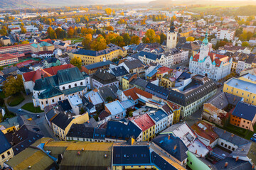 Panoramic aerial view of autumn landscape of Czech town of Sumperk with Church of Saint John Baptist and Town hall at sunrise, Olomouc Region - obrazy, fototapety, plakaty