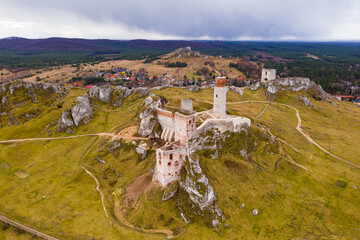 Aerial view of medieval Olsztyn castle ruins on hilltop among limestone rocks in spring, Silesia Province, Poland