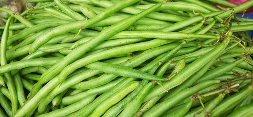 Heap of fresh green beans uncooked. Raw Green Organic French String Beans sold in traditional market Indonesia