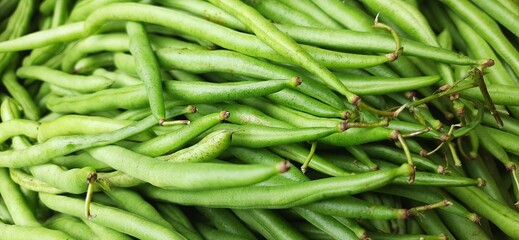 Heap of fresh green beans uncooked. Raw Green Organic French String Beans sold in traditional market Indonesia