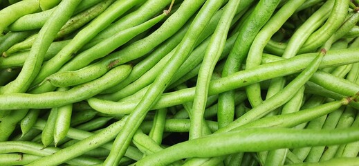 Heap of fresh green beans uncooked. Raw Green Organic French String Beans sold in traditional market Indonesia