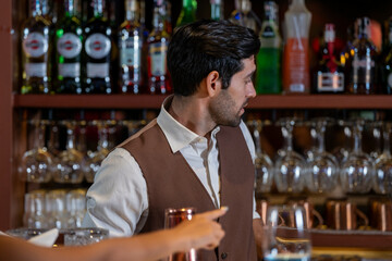 Man bartender is making a drink and dancing at bar. Dance party with group people dancing . Women and men have fun and drinking martini cocktail in night club.