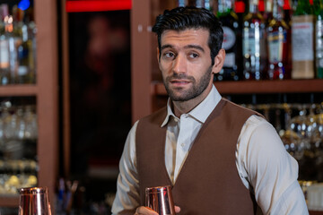 Man bartender is making a drink and dancing at bar. Dance party with group people dancing . Women and men have fun and drinking martini cocktail in night club.