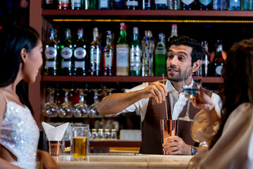 two girls in sexy dress are drinking and dancing at bar. Dance party with group people dancing . Women and men have fun and drinking martini cocktail in night club.