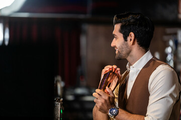 Man bartender is making a drink and dancing at bar. Dance party with group people dancing . Women and men have fun and drinking martini cocktail in night club.